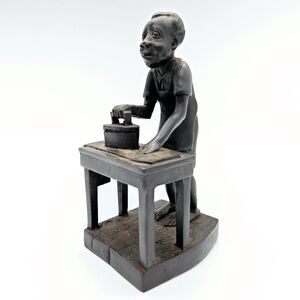 Hand carved wood wooden man ironing African scultpure 6"